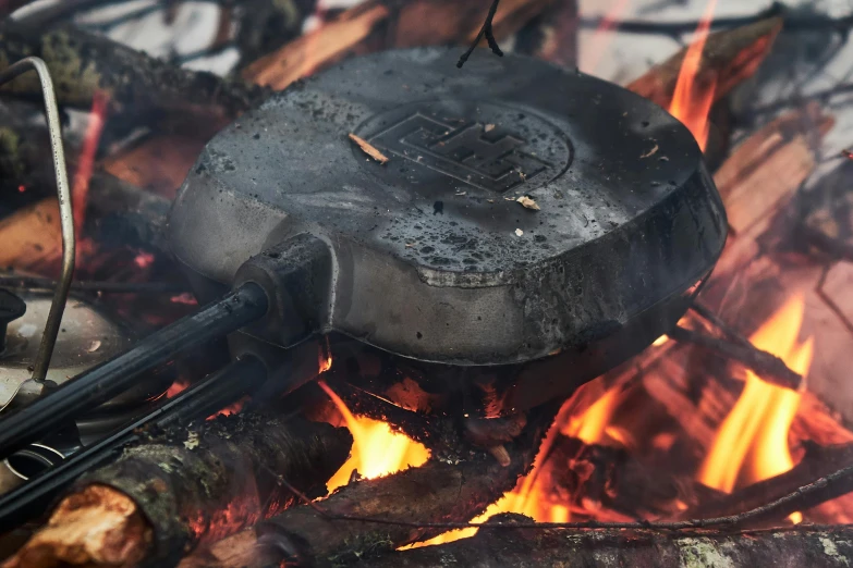 a frying pan sitting on top of an open fire, by Adam Marczyński, hurufiyya, american canteen, up close shot, modeled, foundry vtt