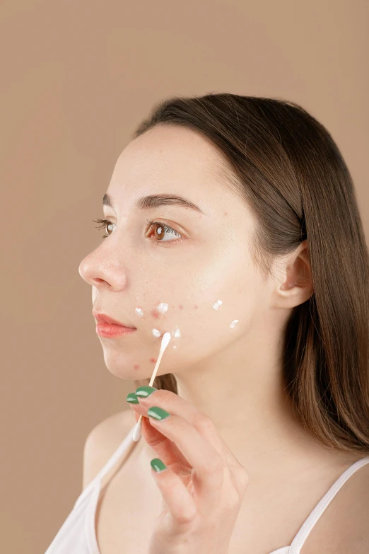 a woman brushing her teeth with a toothbrush, by Adam Marczyński, trending on pexels, hyperrealism, trypophobia acne face, square facial structure, beauty mark on cheek, candy treatments