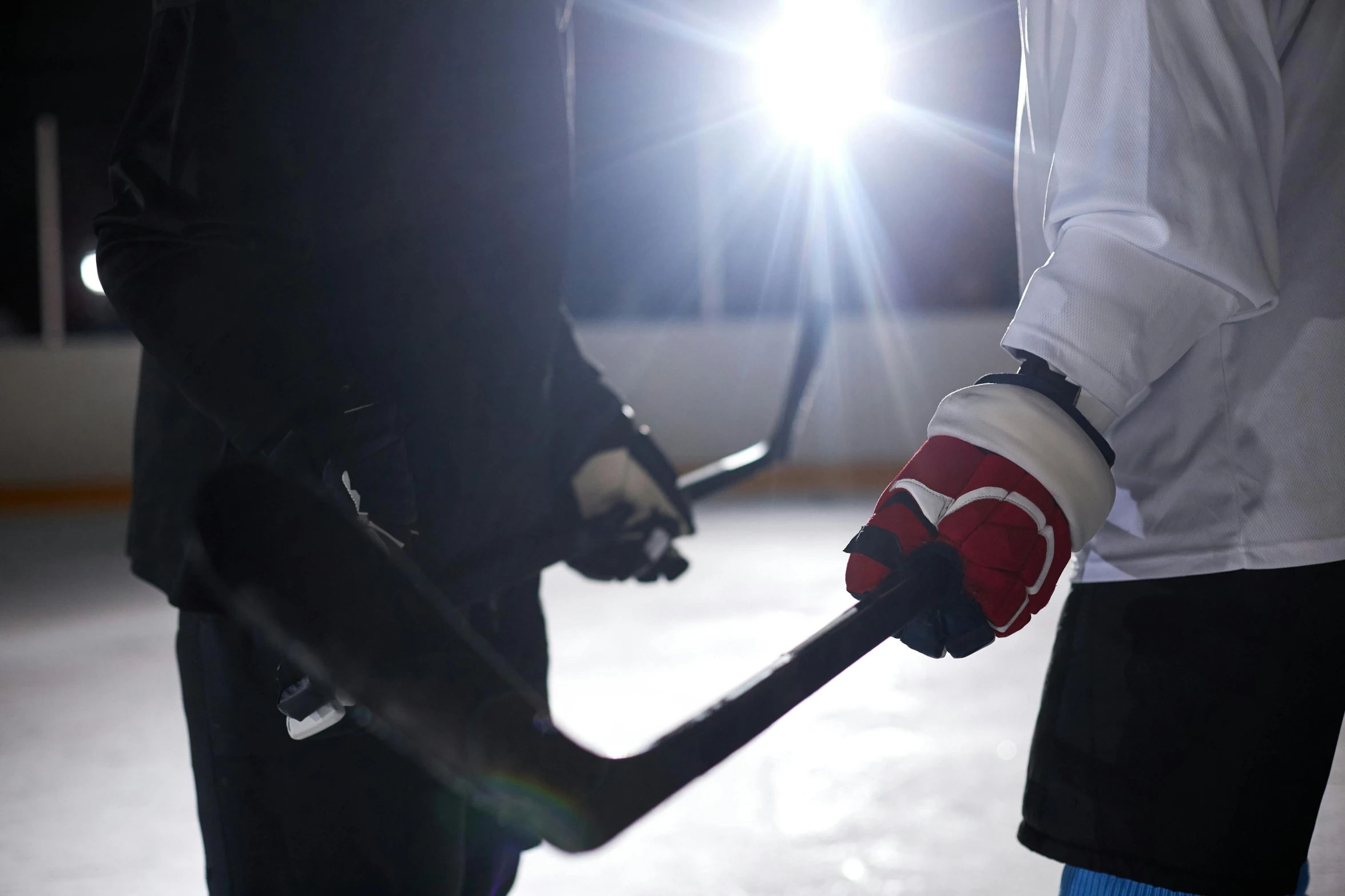 a close up of a person holding a hockey stick, sparring, grey