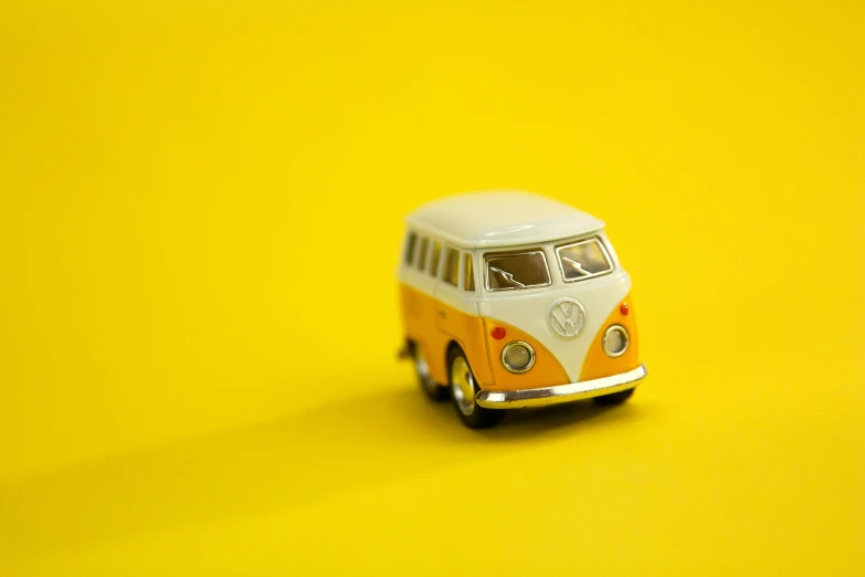 a toy van sitting on top of a yellow surface, pexels contest winner, microbus, miniatures, fan favorite, canvas