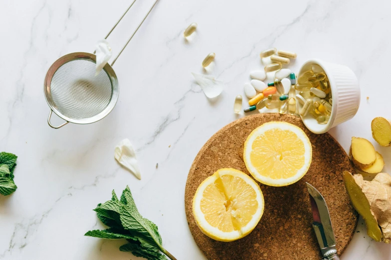 a cutting board topped with sliced lemons and herbs, a still life, trending on pexels, pills and medicine, made of liquid metal and marble, canva, background image