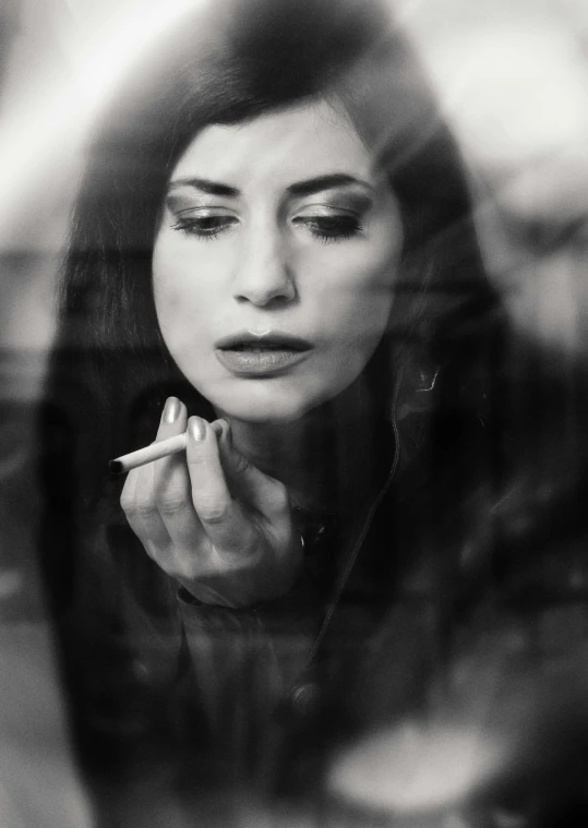 a woman smoking a cigarette in front of a mirror, a black and white photo, inspired by Elsa Bleda, pexels contest winner, art photography, woman with black hair, double exposure of love, photo - realistic ), portait of haifa wehbe