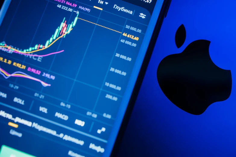 a close up of a cell phone with an apple logo on it, a digital rendering, by Adam Marczyński, shutterstock, displaying stock charts, blue and purple scheme, colorful digital screens) xf iq4, trading