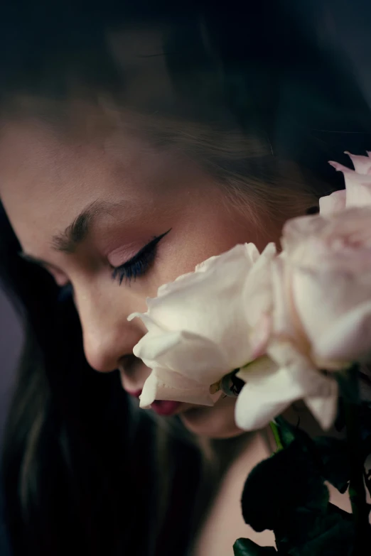 a close up of a person holding a bunch of flowers, deep in thought, portrait of ariana grande, cinematic shot ar 9:16 -n 6 -g, white roses