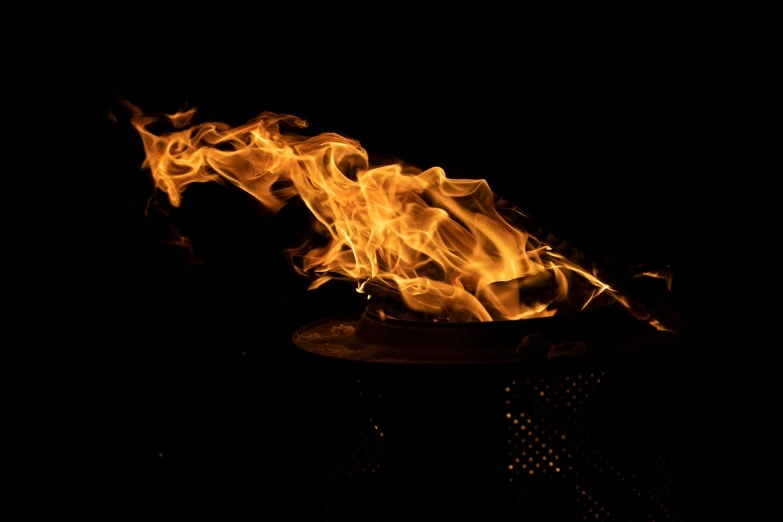 a close up of a fire on a grill, an album cover, by Daniel Lieske, pexels contest winner, process art, fire tornado, skatepark in flames, avatar image, tiny firespitter