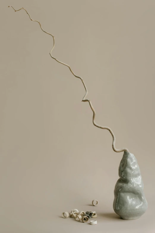 a vase with a branch sticking out of it, an abstract sculpture, inspired by Lucio Fontana, unsplash, sandworm, female ascending, upward shot, ignant