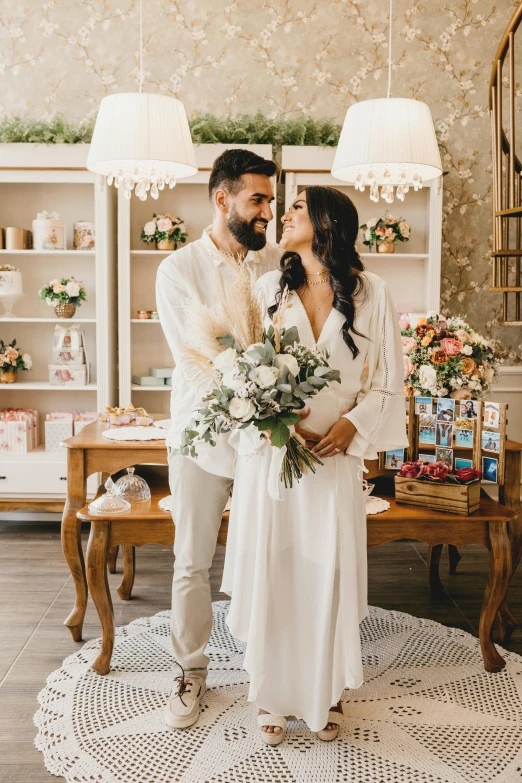 a man and woman standing next to each other in a room, pexels contest winner, romanticism, in a white boho style studio, flower shop scene, low, holy