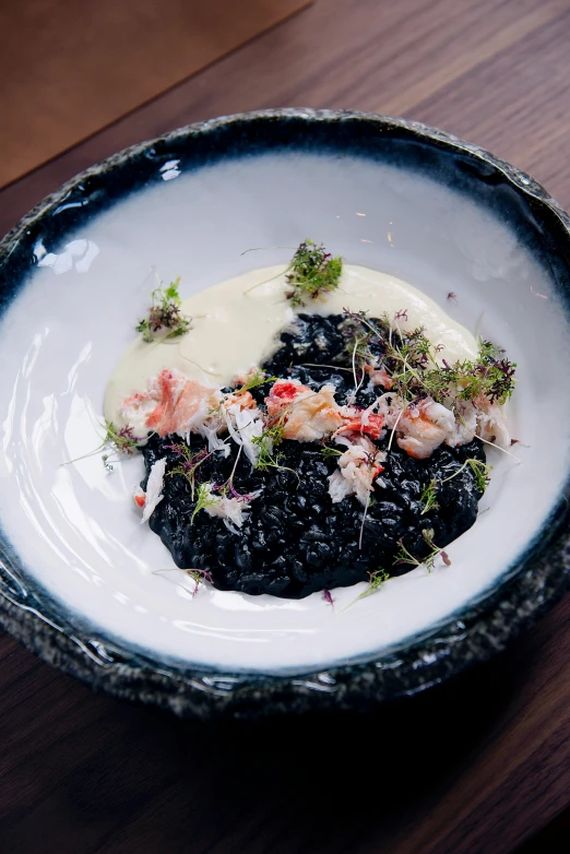 a close up of a bowl of food on a table, inspired by Ceferí Olivé, black slime, lobster, white on black, thumbnail