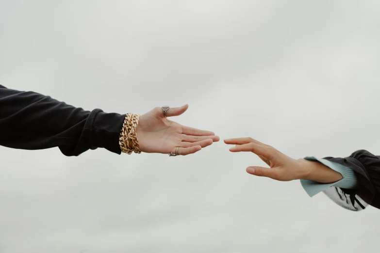 two people reaching out to touch each other, trending on pexels, slight overcast lighting, humanisation, looking towards the camera, promo image