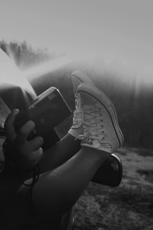 a black and white photo of a person spraying water, inspired by Dorothea Lange, pexels contest winner, realism, sneaker photo, holding a torch, gamer aesthetic, picnic