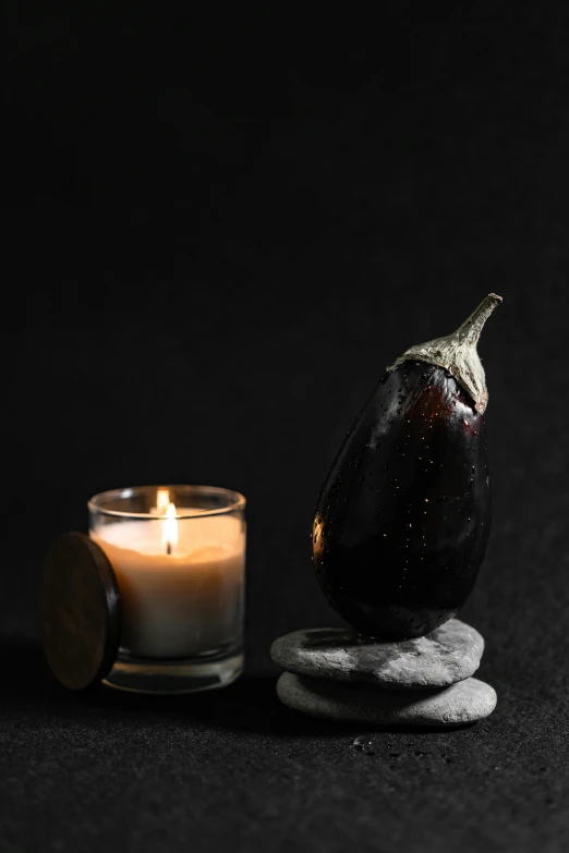 an eggplant next to a candle on a black background, curated collection, asset on grey background, subtle detailing, slate
