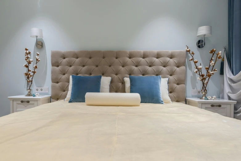 a bed room with a neatly made bed, inspired by Albert Paris Gütersloh, unsplash, cream and blue color scheme, bedhead, vip room, angled