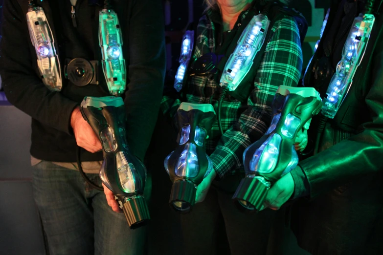 a couple of people that are holding some lights, a hologram, holding arms on holsters, group photo, pov, prosthetic arm