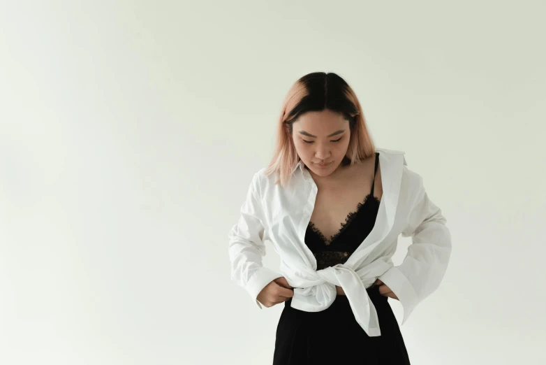 a woman in a white shirt and black skirt, inspired by Xia Chang, trending on unsplash, wearing bra, dressed in a robe, white backround, wearing a crop top