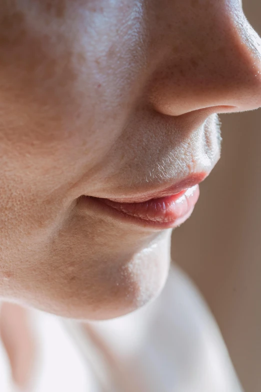 a close up of a person holding a cell phone, by Sven Erixson, hyperrealism, focus on pursed lips, light stubble, profile view, soft portrait shot 8 k