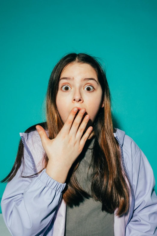 a woman with a surprised look on her face, shutterstock, teal color graded, thalassophobia, teenage girl, instagram post