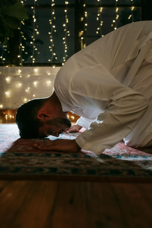 a man is doing a yoga pose on the floor, hurufiyya, doing a prayer, middle of the night, profile image, on the altar