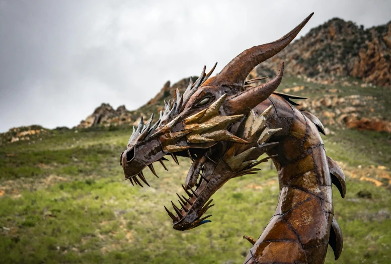 a close up of a sculpture of a dragon, by Daniel Lieske, pexels contest winner, with mountains as background, avatar image, spiked scrap metal armor, devils horns