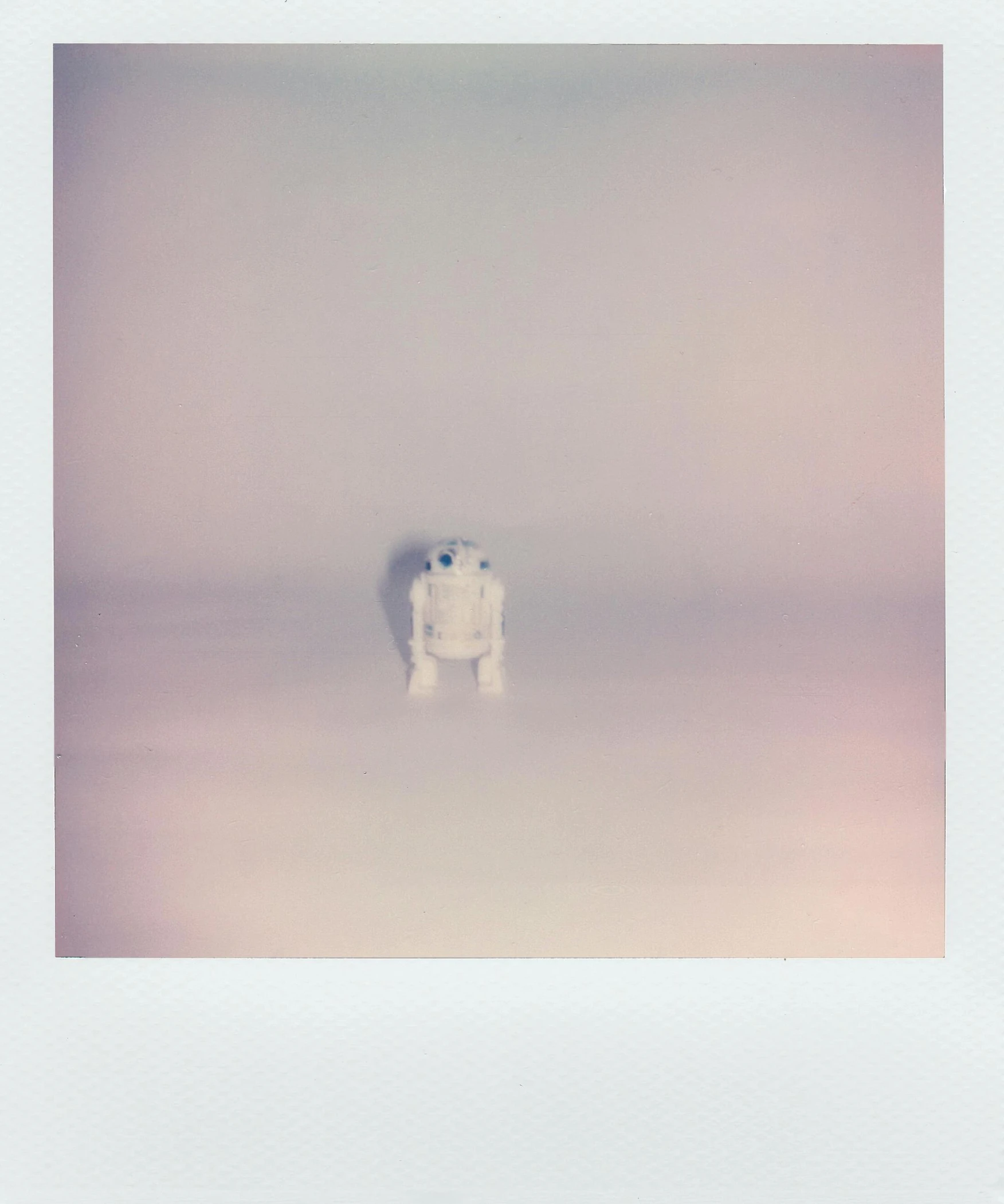 a polar bear sitting on top of a snow covered ground, a polaroid photo, by Ryan Pancoast, postminimalism, < full body robot >, colored fog, hyperminimalist, without frame