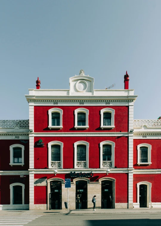 a red building with a clock on the top of it, inspired by Wes Anderson, pexels contest winner, quito school, profile image, jerez, neoclassical architecture, freddy mamani silvestre facade