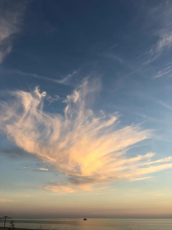 a bench sitting on top of a beach next to the ocean, unsplash, romanticism, a dragon made of clouds, # nofilter, sherbert sky, angels in the sky