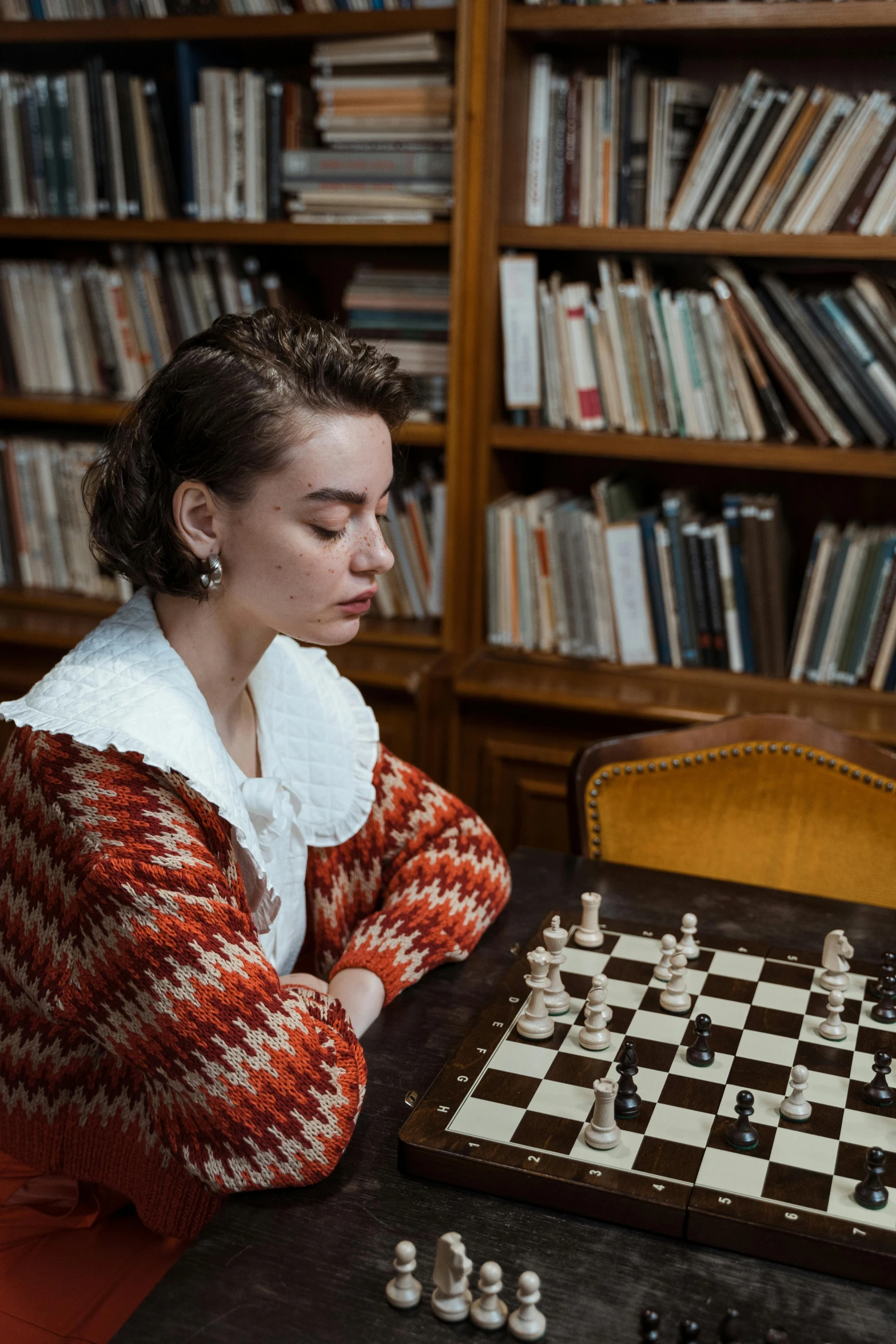 a woman sitting at a table playing a game of chess, a portrait, inspired by Elsa Bleda, unsplash contest winner, mannerism, in a library, wearing a fancy jacket, portrait sophie mudd, ignant