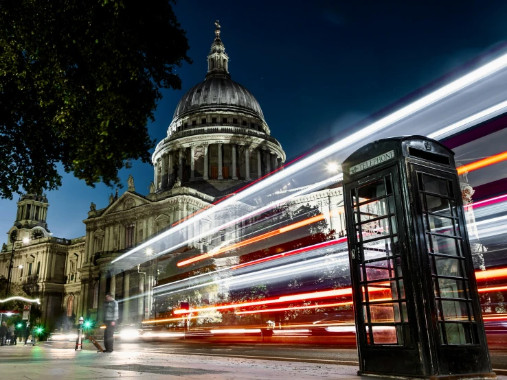 a telephone booth sitting on the side of a street, an album cover, by Christopher Wren, busy night, pantheon, thumbnail, tram