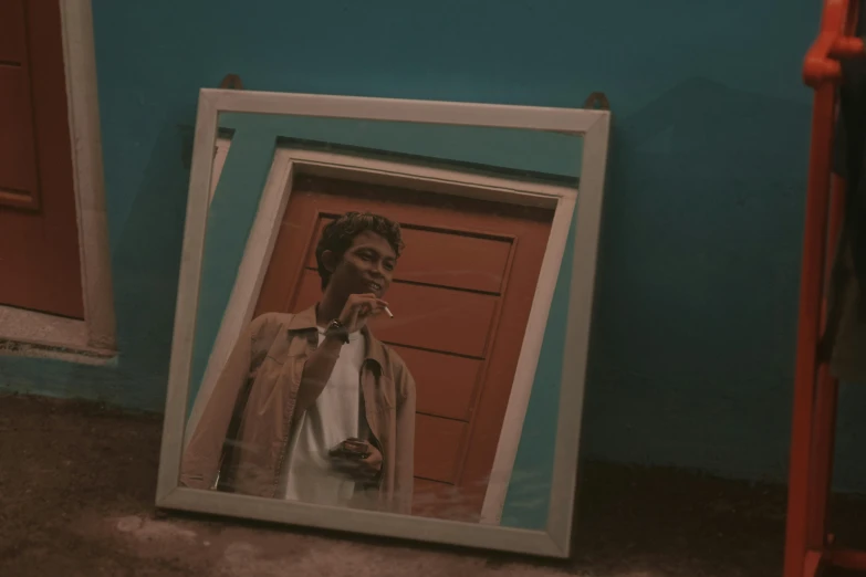 a man taking a picture of himself in a mirror, a polaroid photo, by Elsa Bleda, pexels contest winner, hyperrealism, brown and cyan color scheme, smoking woman, imaan hammam, about to enter doorframe