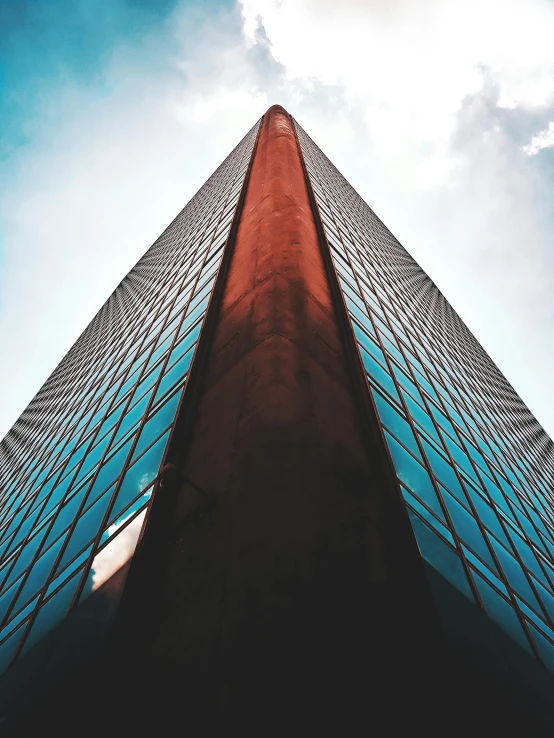 a tall building with a blue sky in the background, an album cover, by Adam Rex, unsplash contest winner, hypermodernism, glass obelisk of the void, red building, instagram story, ultra - realism