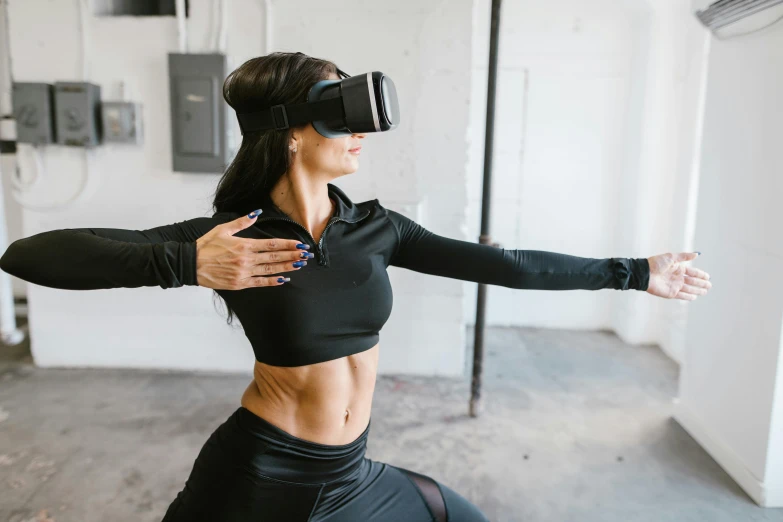 a woman wearing a virtual reality headset in a room, trending on pexels, sporty physique, arms extended, yummy, black