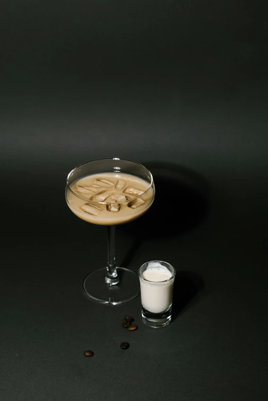 a drink sitting on top of a glass next to a cup of coffee, inspired by Carlo Martini, renaissance, soey milk, front facing, 4 2 0, assembled