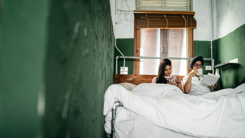 a couple of people that are laying in a bed, trending on pexels, happening, abandoned hospital room, in chippendale sydney, two women, checking her phone