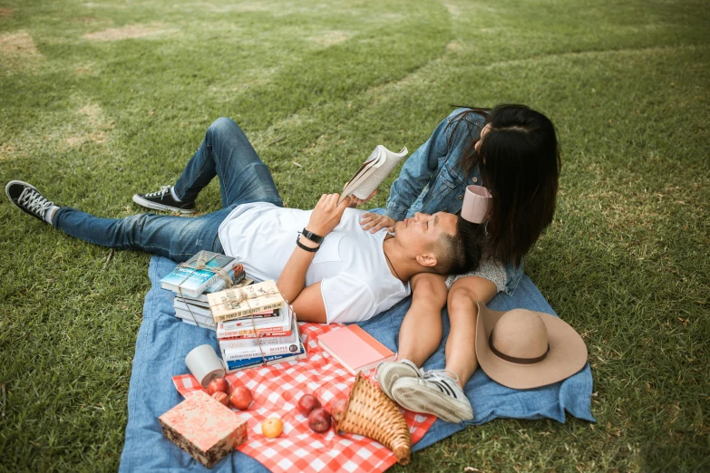 a man and woman laying on a blanket in the grass, by Carey Morris, pexels contest winner, holding books, mukbang, sydney park, avatar image