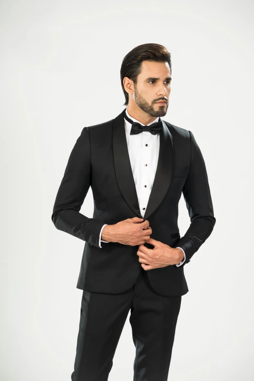 a man in a tuxedo standing with his hands in his pockets, inspired by Ramon Pichot, black jacket | shiny, front