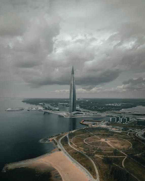 a large body of water next to a tall building, pexels contest winner, surrealism, capital of estonia, the sky is gray, satelite imagery, towering over your view