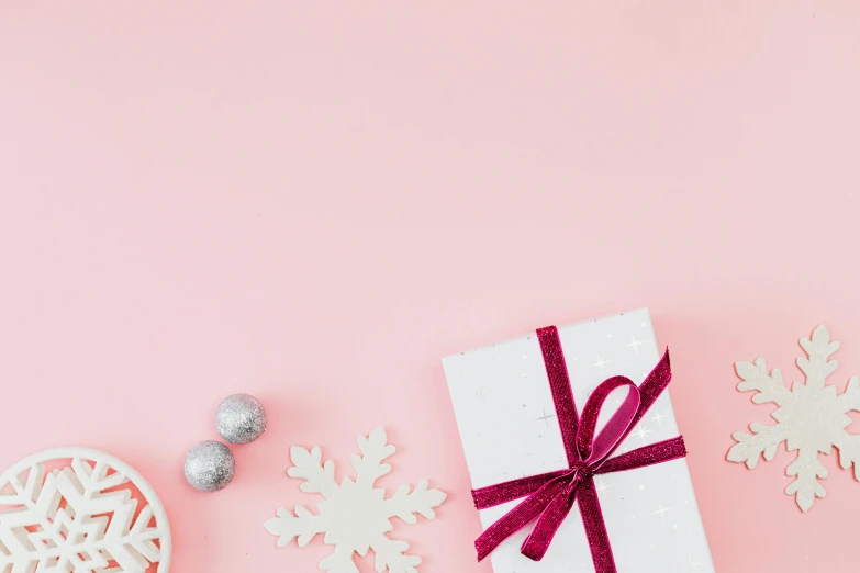 a white present surrounded by snowflakes on a pink background, pexels contest winner, minimalism, background image, various items, thumbnail, ribbon