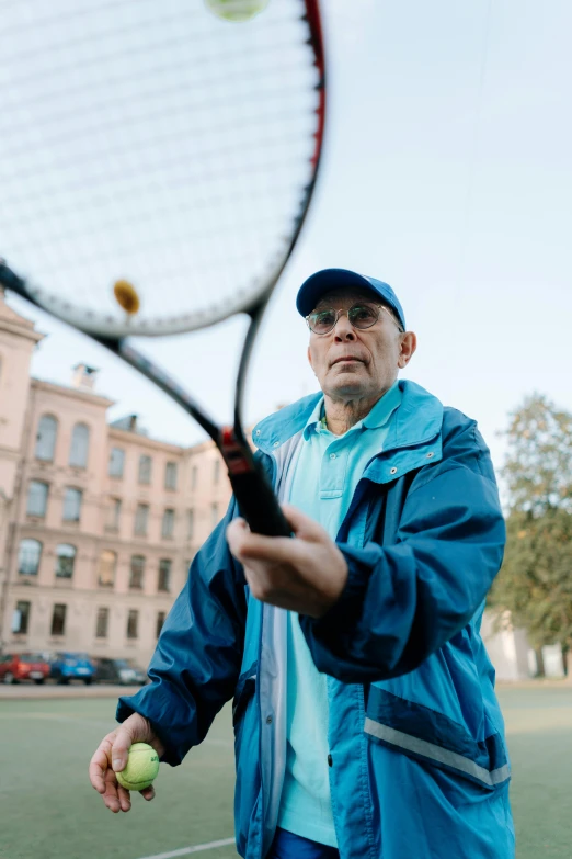 a man standing on top of a tennis court holding a racquet, pekka halonen, shot with sony alpha, old man, information