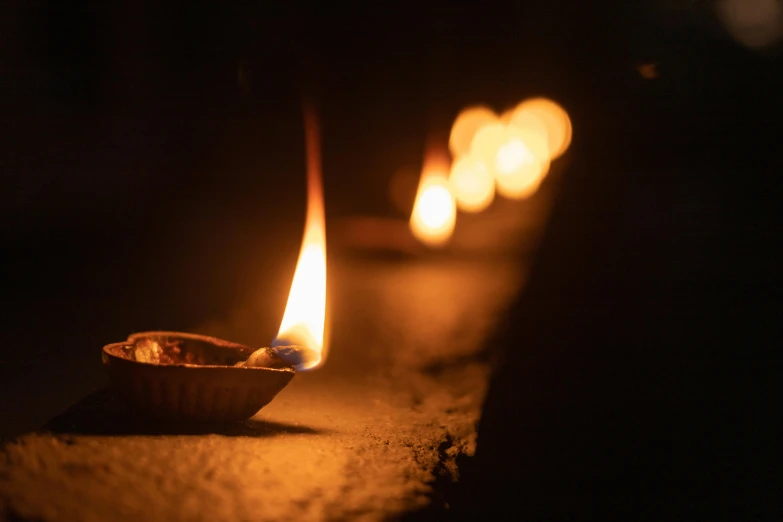 a group of lit candles sitting next to each other, pexels contest winner, wall torches, indian temple, photograph taken in 2 0 2 0, print ready