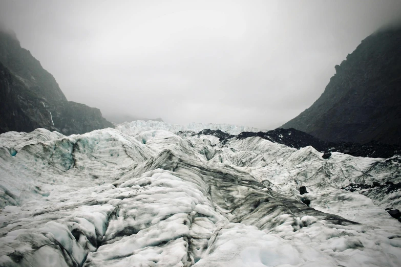 a group of people standing on top of a glacier, hues of subtle grey, top selection on unsplash, new zealand, armor made of ice