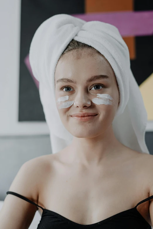 a woman with a towel wrapped around her head, pexels contest winner, white cheeks, teen girl, white facepaint, photoshoot for skincare brand