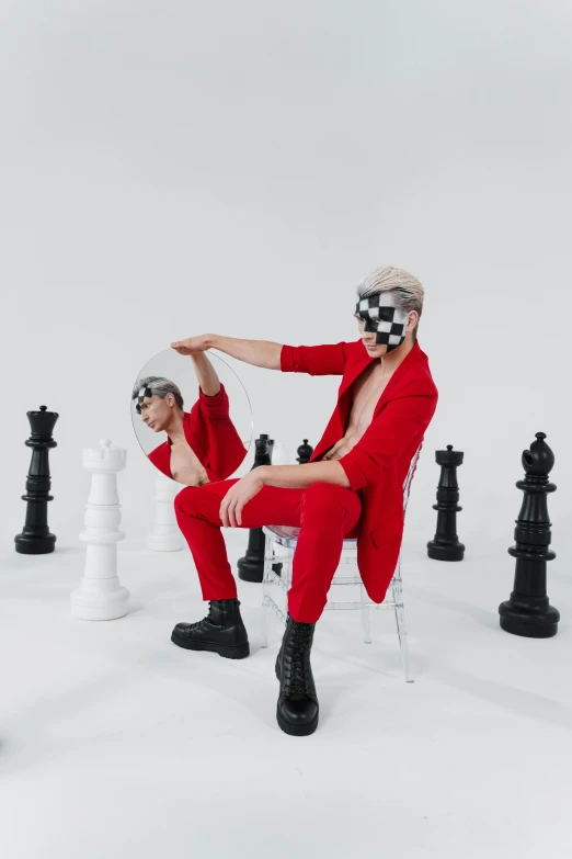 a couple of people sitting on top of a chess board, an album cover, inspired by Wang Duo, trending on pexels, red suit, an epic non - binary model, youtube thumbnail, xqc