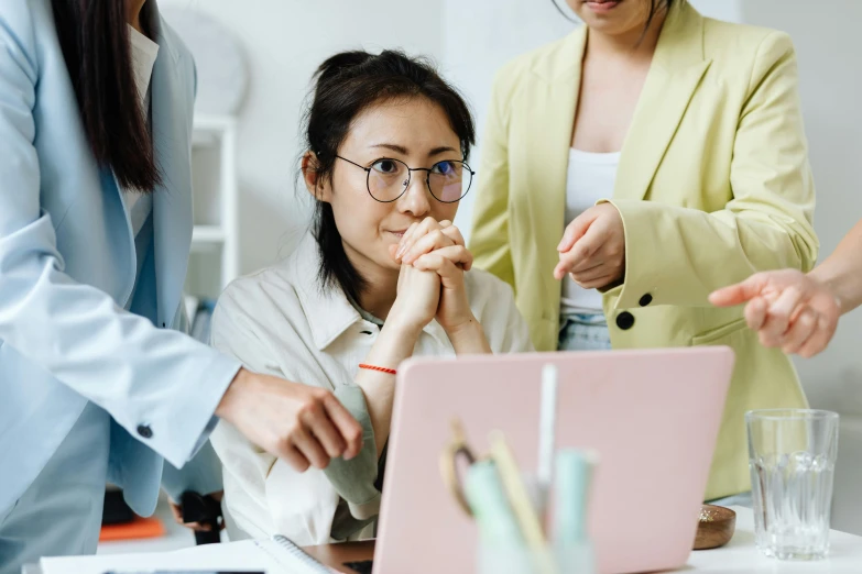 a group of women standing around a laptop computer, by Jang Seung-eop, trending on pexels, wearing small round glasses, avatar image, pondering, professional image