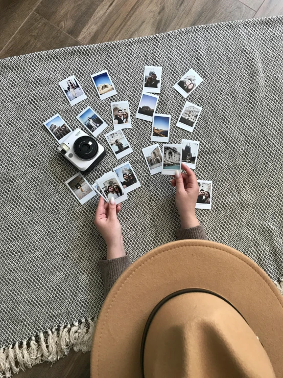 a person sitting on a rug with a hat and polar polar polar polar polar polar polar polar polar polar polar polar polar polar polar polar polar polar, a polaroid photo, by Lucia Peka, unsplash, holding polaroid camera, lots of pictures, flatlay, medium-format print