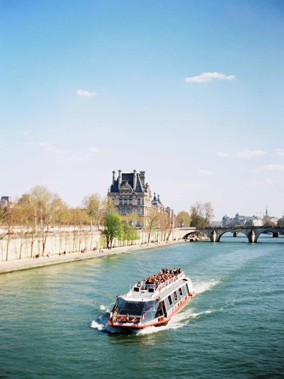 a boat traveling down a river next to a bridge, a photo, by Julia Pishtar, paris school, sunny day time, 🚿🗝📝