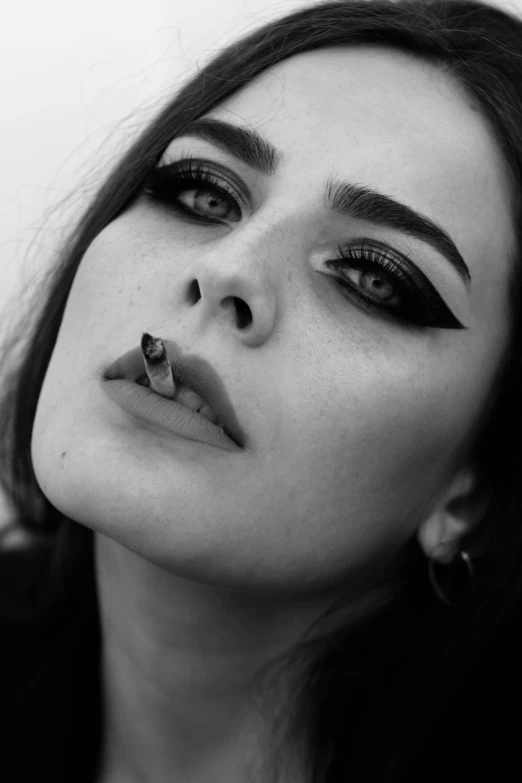 a black and white photo of a woman with piercings, inspired by Kati Horna, tumblr, kaya scodelario, with a cigarette in its mouth, billie eilish as female loki, deviantart artstation cgscosiety