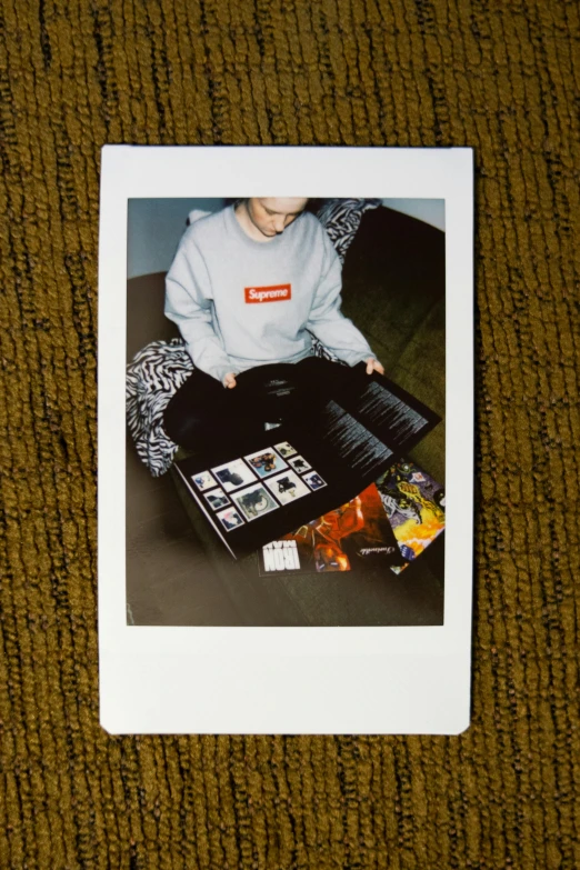 a polaroid picture of a young boy sitting on the floor, a polaroid photo, konami hyperboy, in suitcase, hypebeast, - 8