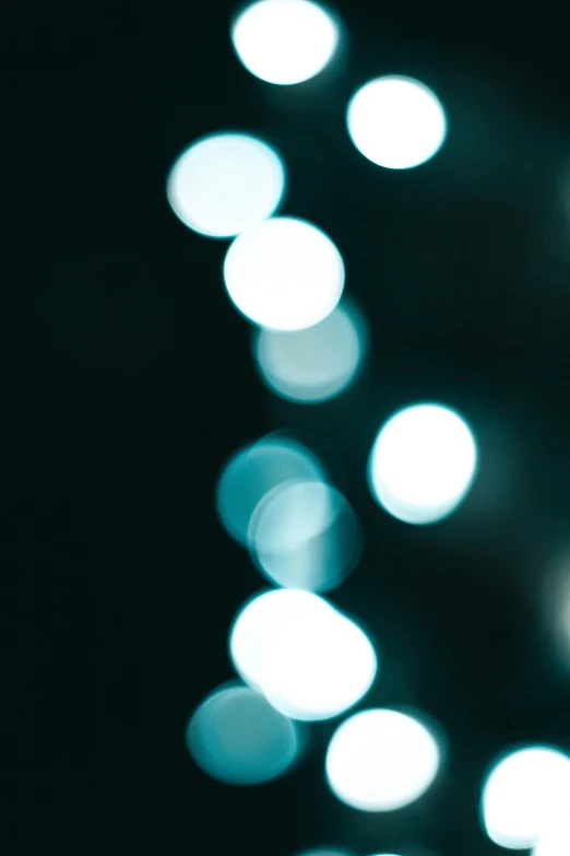 a bunch of lights that are in the dark, a picture, inspired by Elsa Bleda, unsplash, digital art, blue blurred, black and teal paper, holiday season, soft blue moonlight