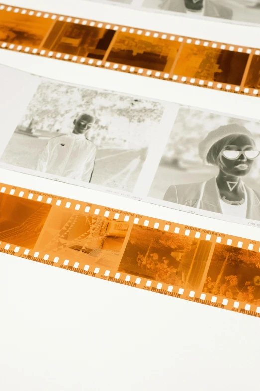 a roll of film sitting on top of a table, inspired by Jan Kupecký, shades of aerochrome gold, detail shot, platinum printing, looking towards camera