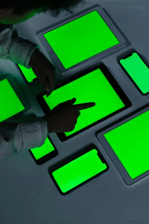 a person using a laptop with a green screen, a digital rendering, inspired by Bruce Nauman, unsplash, interactive art, softly glowing control panels, phone photo, futuristic chemistry lab, photo taken from above