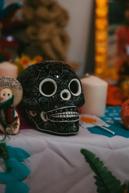 a couple of skulls sitting on top of a table, on a table, multi - coloured, religious, face showing